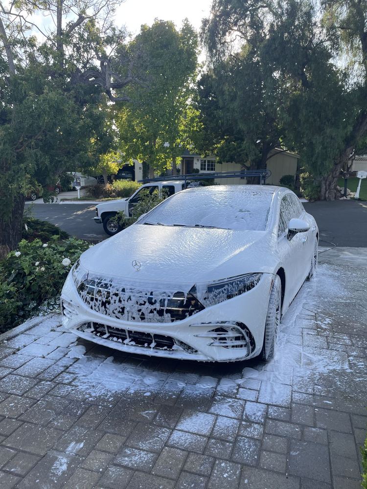 White Mercedes-AMG during a foam wash